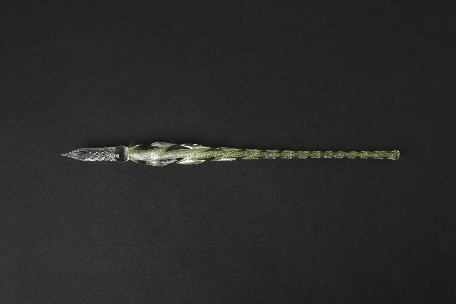 Transparent glass crystal pen with coloured ink visible inside, abstract modelling design