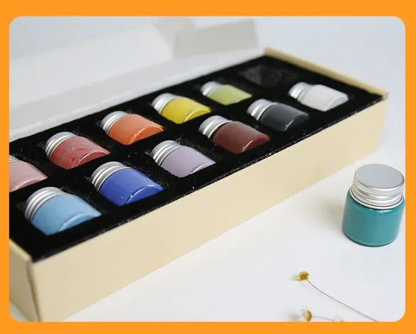 Pots of Morandi colour ceramic glaze paint in Lilac, Plant Ash, and Verdant for high temperature pottery firing.