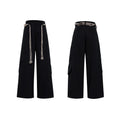 Men's dark blue loose-fit straight-leg cotton trousers with zipper decoration and tassel detail.