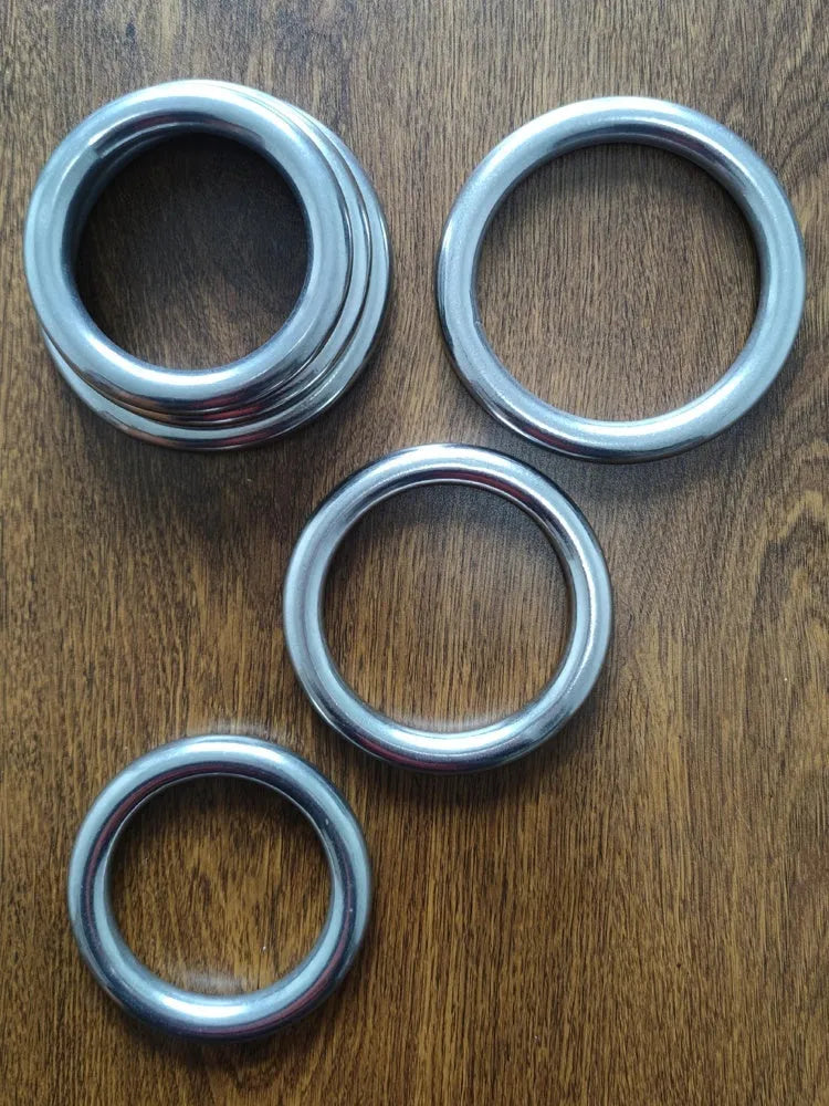 Iron Arm Skill Wing Chun carbon steel power training ring in three sizes on a plain background.