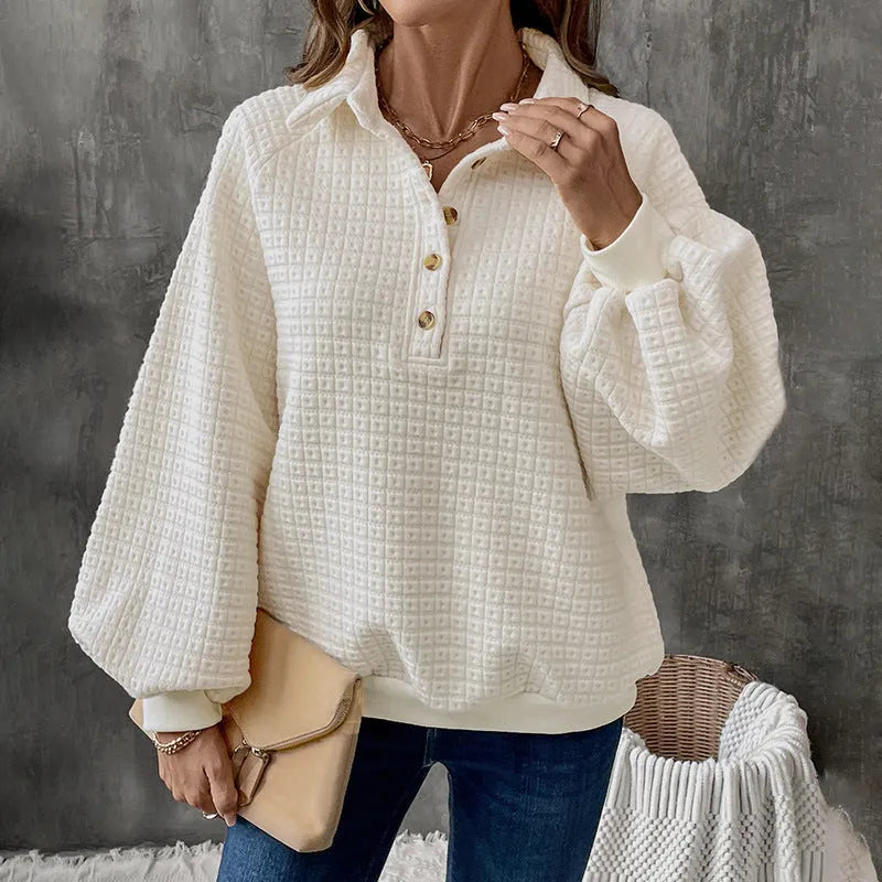 Beige women's knitted sweater with a polo collar and long sleeves laid flat.