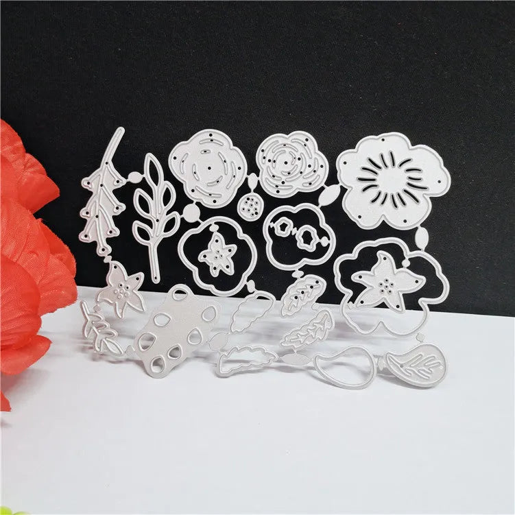 Silver carbon steel paper cutting mould with etched floral design measuring 14.3 by 9.9 centimetres