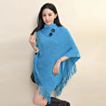 Women's triangular plush shawl cape in cashmere-acrylic blend with tassel trim, shown in various colours.
