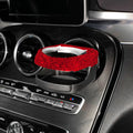 Sparkling rhinestone car cup holder bracket clipped to a vehicle air vent, shown in pink diamond colour.