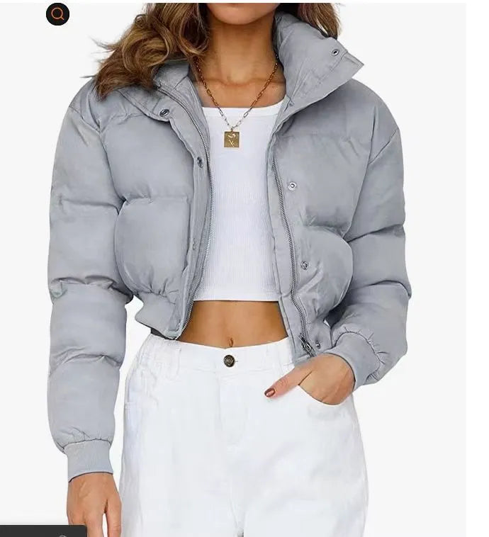 Women's loose blue polyester jacket with long sleeves on a hanger.