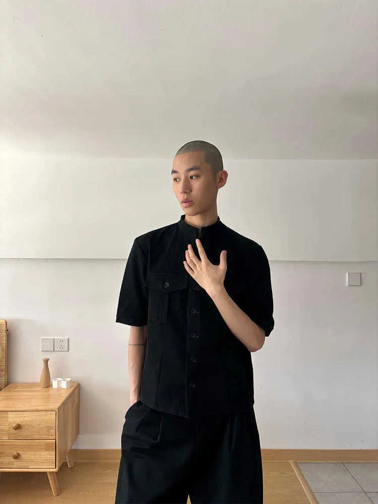 Handmade black loose fit half sleeve button-down shirt for men, shown on a hanger.