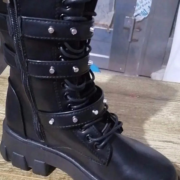 Women's black mid-calf knight boots with metal buckle and side zipper on a round toe.