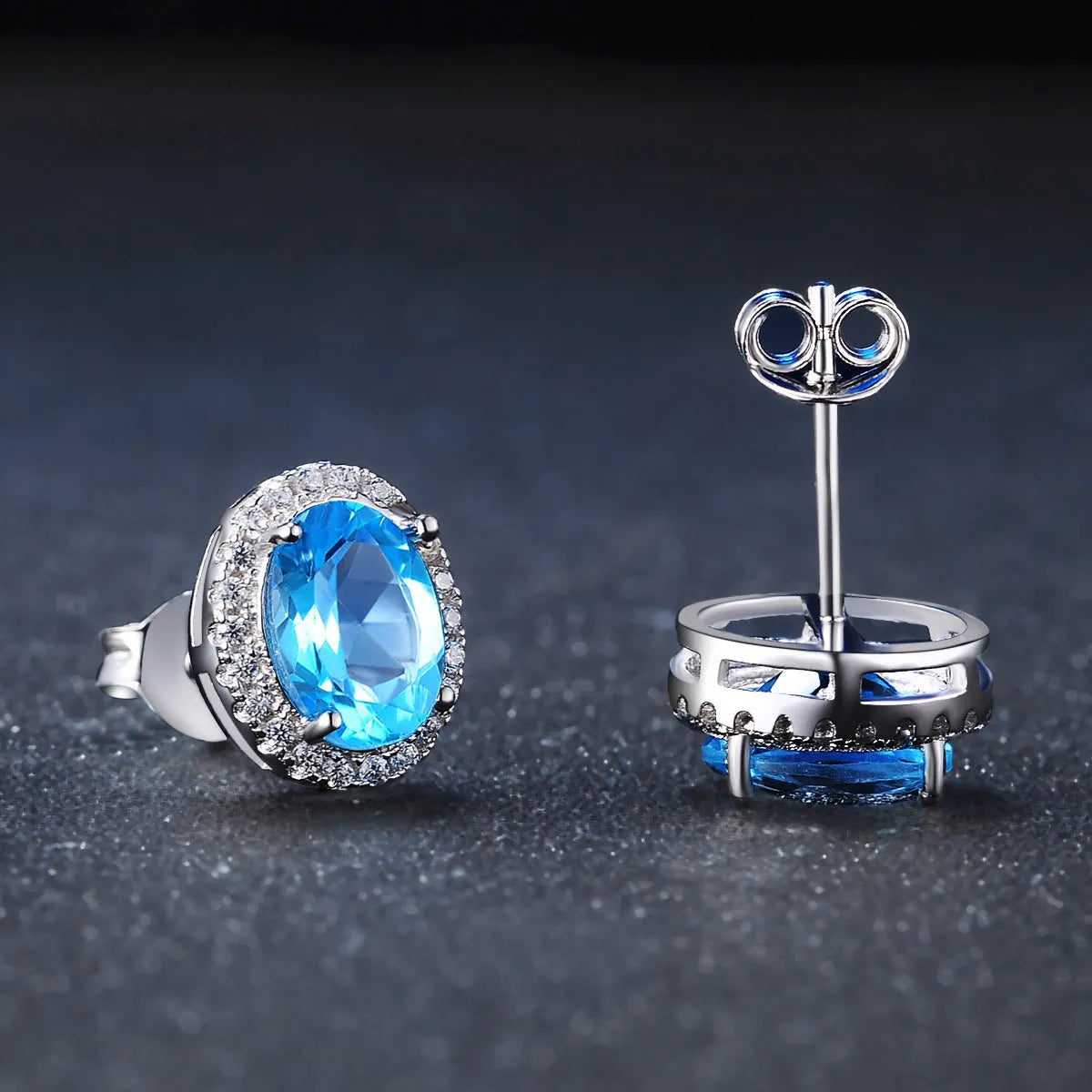 925 sterling silver jewellery set with blue topaz gems showing earrings, ring, pendant and necklace with geometric design