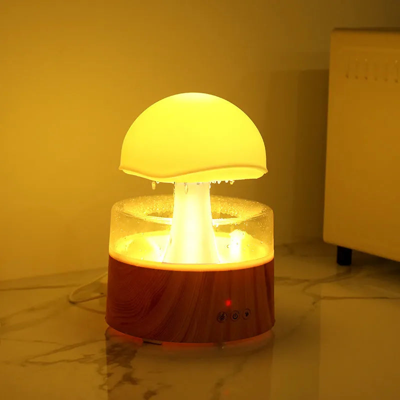 White Rain Cloud Humidifier showing raindrop effect, colour-changing light, and remote control on a table.