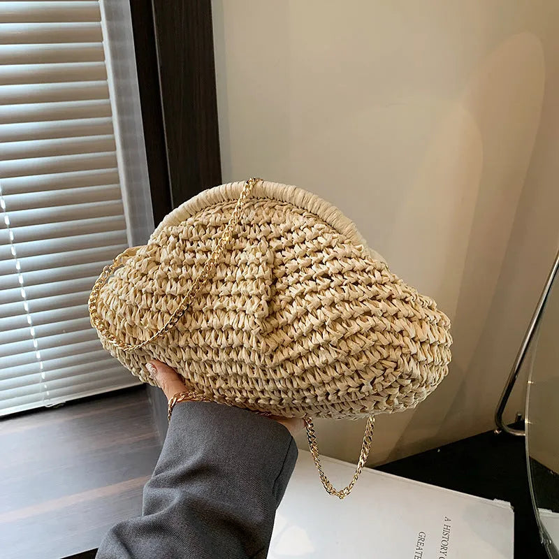 Shell-shaped straw beach bag with chain strap in khaki colour showing zippered pocket