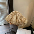 Shell-shaped straw beach bag with chain strap in khaki colour showing zippered pocket
