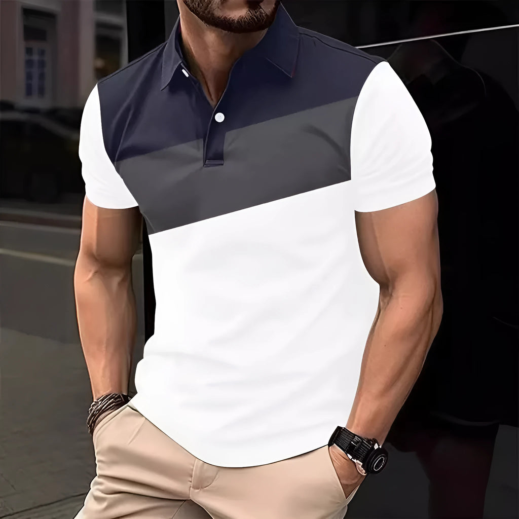 Man modelling a loose-fit grey T-shirt with a colourful 3D digital print pattern on the front.