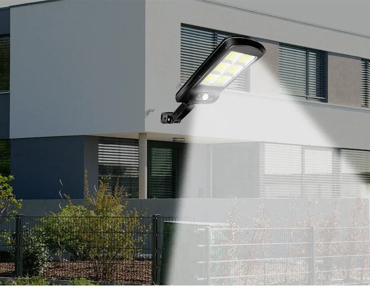 Black outdoor solar motion sensor light for garden or pathway mounting.