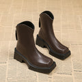 Black women's platform Martin boots with a square toe, mid-calf height, and a back zip.