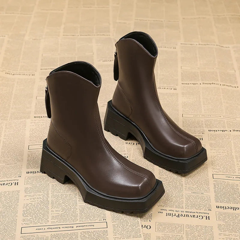 Black women's platform Martin boots with a square toe, mid-calf height, and a back zip.