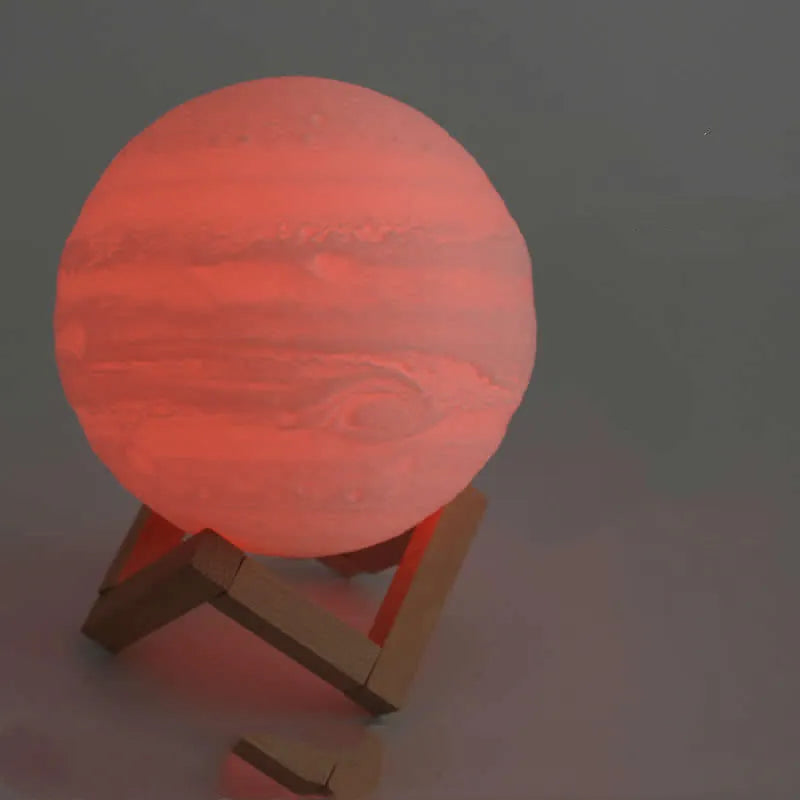 3D printed white moon lamp with textured surface on a wooden stand, showing touch ring at base.