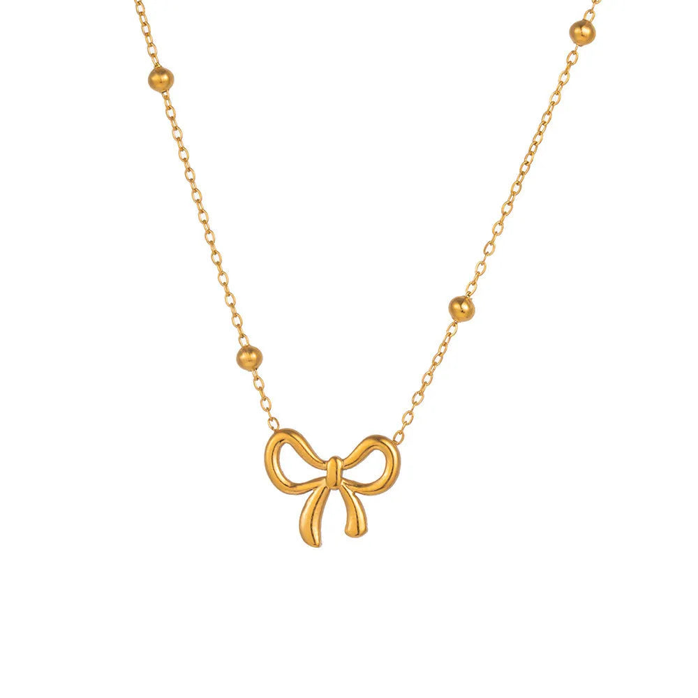 Gold electroplated titanium steel bow necklace with adjustable cross chain
