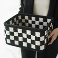 Grey and black checkerboard woven felt folding storage box with collapsible sides.
