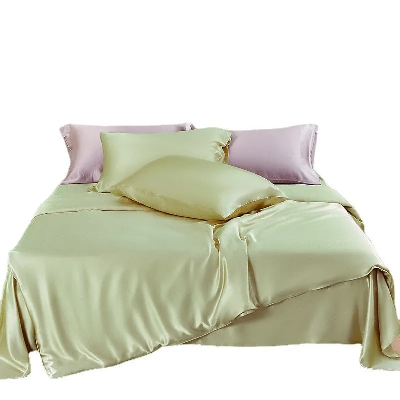 Double-sided solid colour silk duvet cover shown in Lotus Pink on a bed