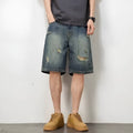 Retro blue denim men's shorts with distressed holes and straight leg cut on mannequin