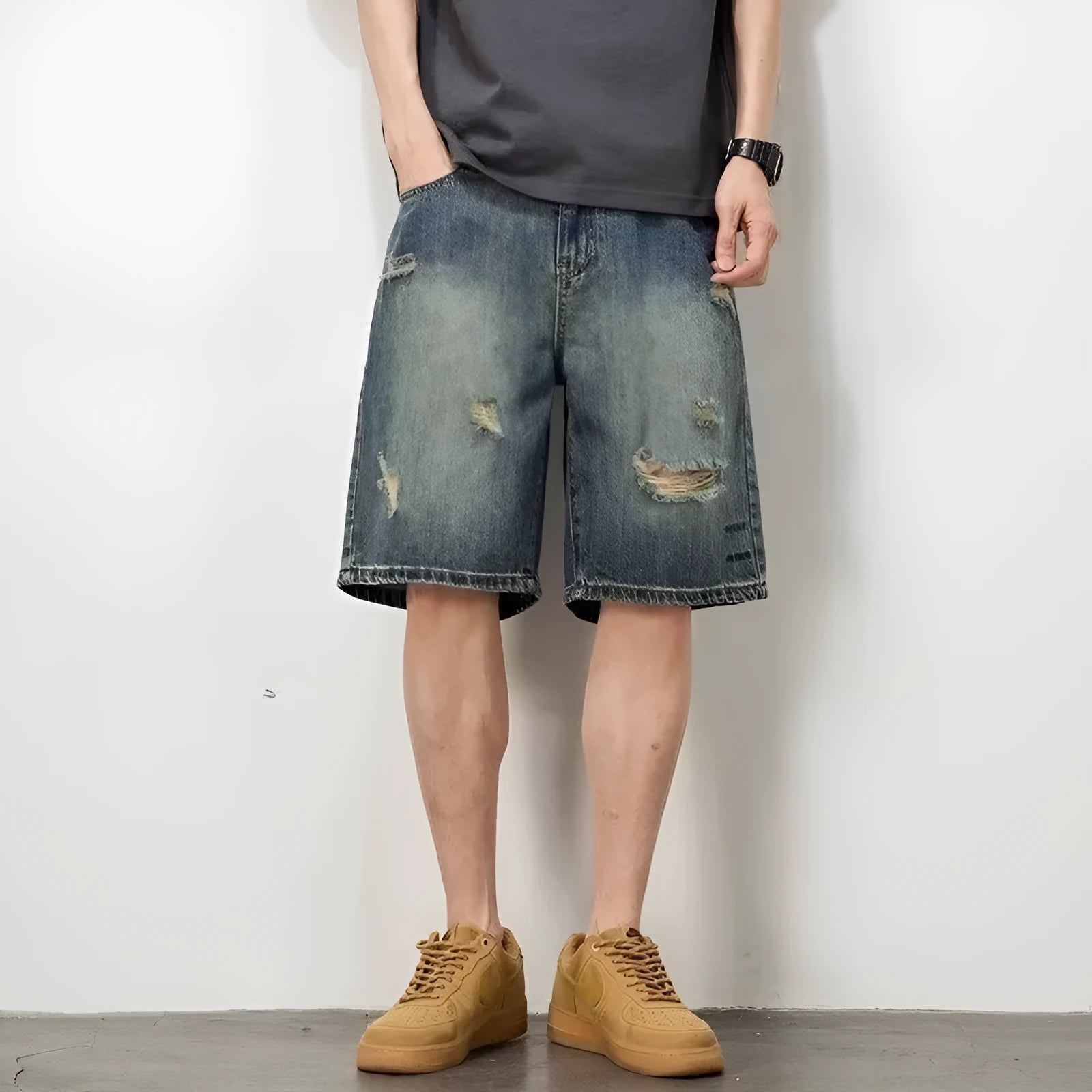 Retro blue denim men's shorts with distressed holes and straight leg cut on mannequin