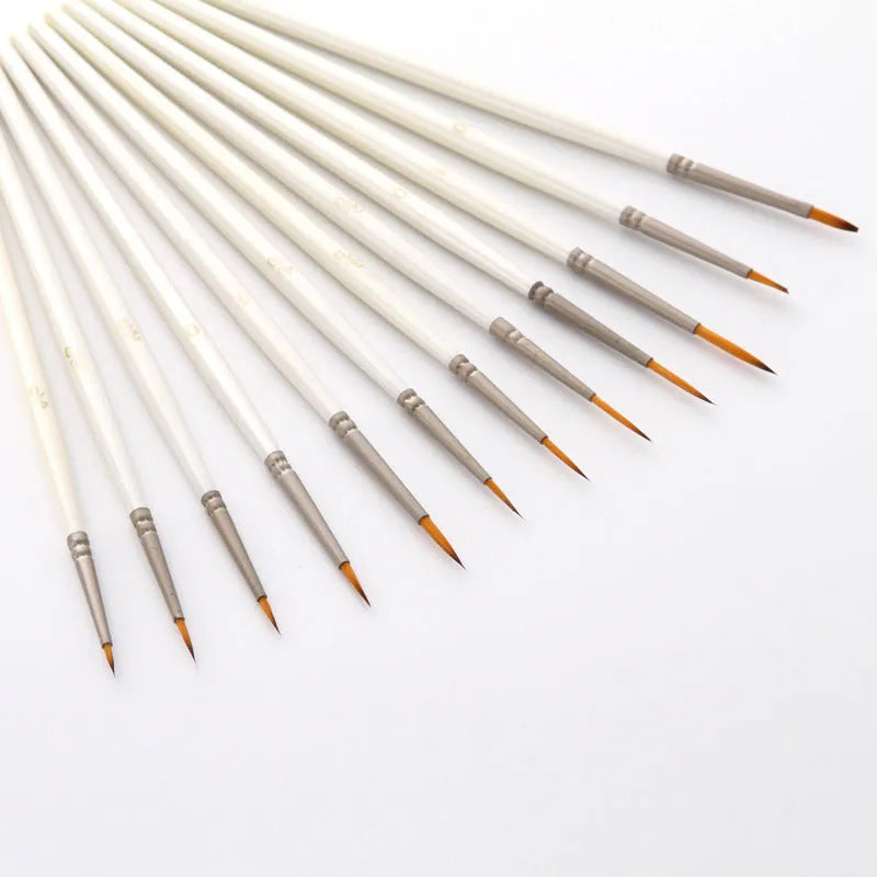 Set of twelve pearl white fluorescent marker pens with nylon wool brush tips for artists.