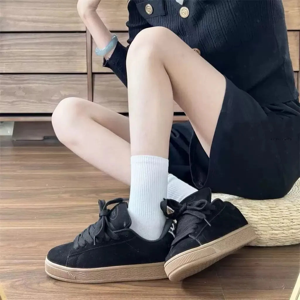 Black retro low-top sneakers with round toe design and waterproof platform construction
