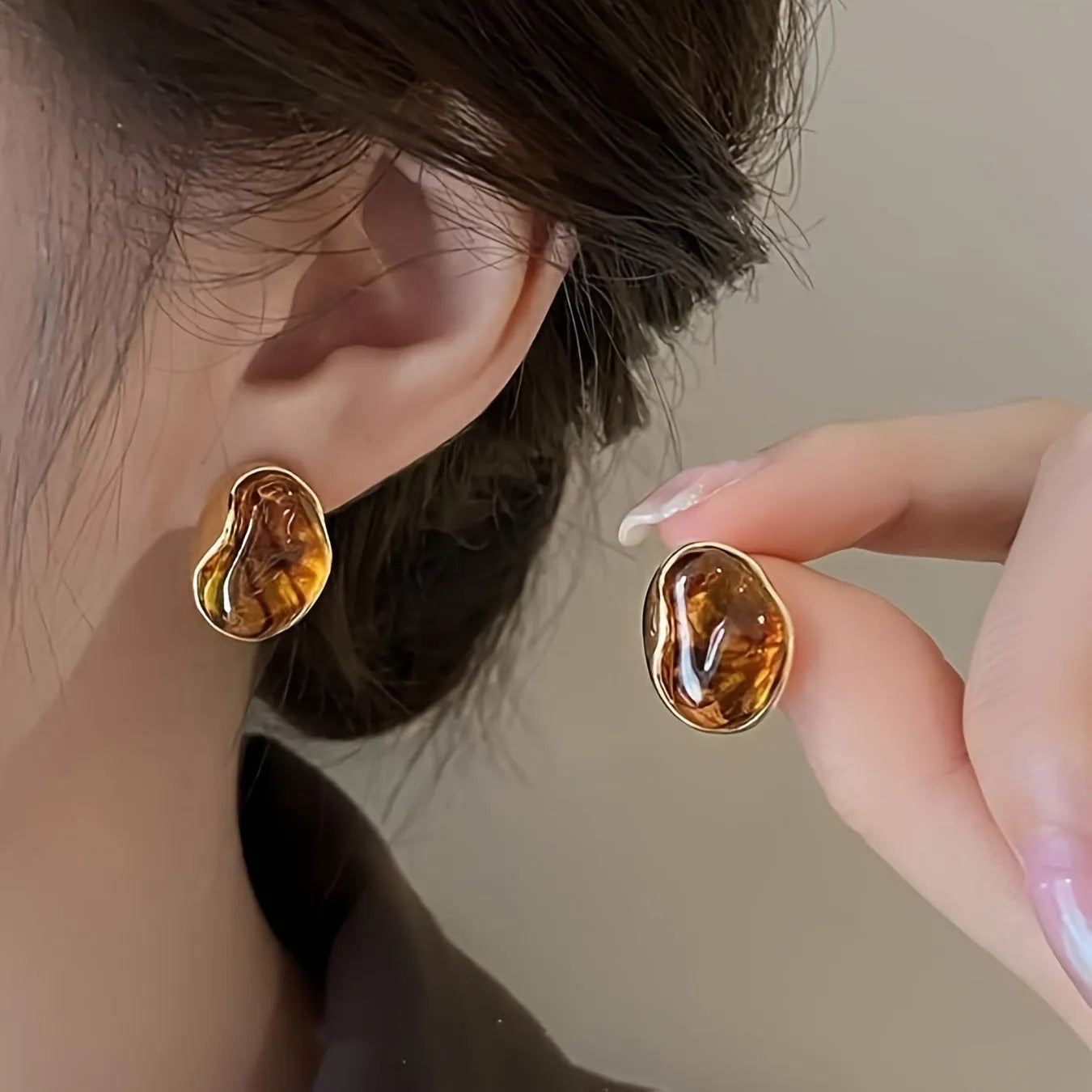 Three pairs of geometric holiday earrings with tassel accents in different styles and colours