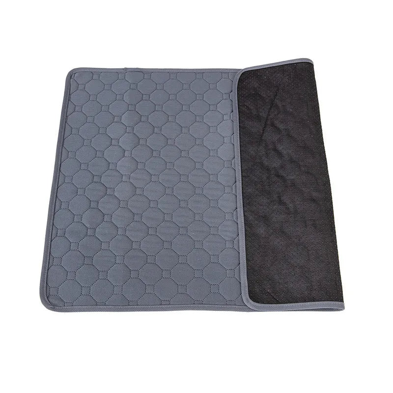 Grey and khaki washable waterproof dog pee pads on a wooden floor.
