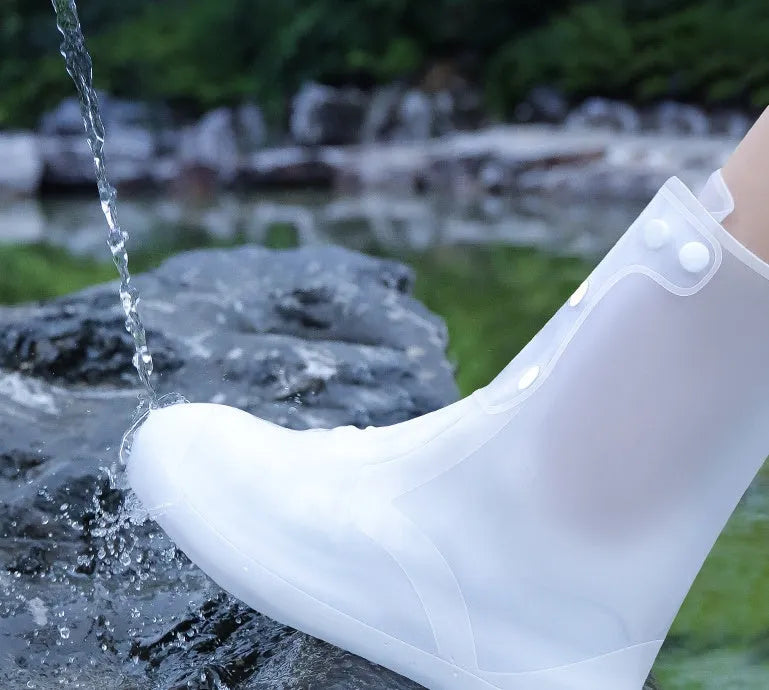 White PVC high-top reusable shoe covers for women, shown on a shoe for rainy day outdoor protection.