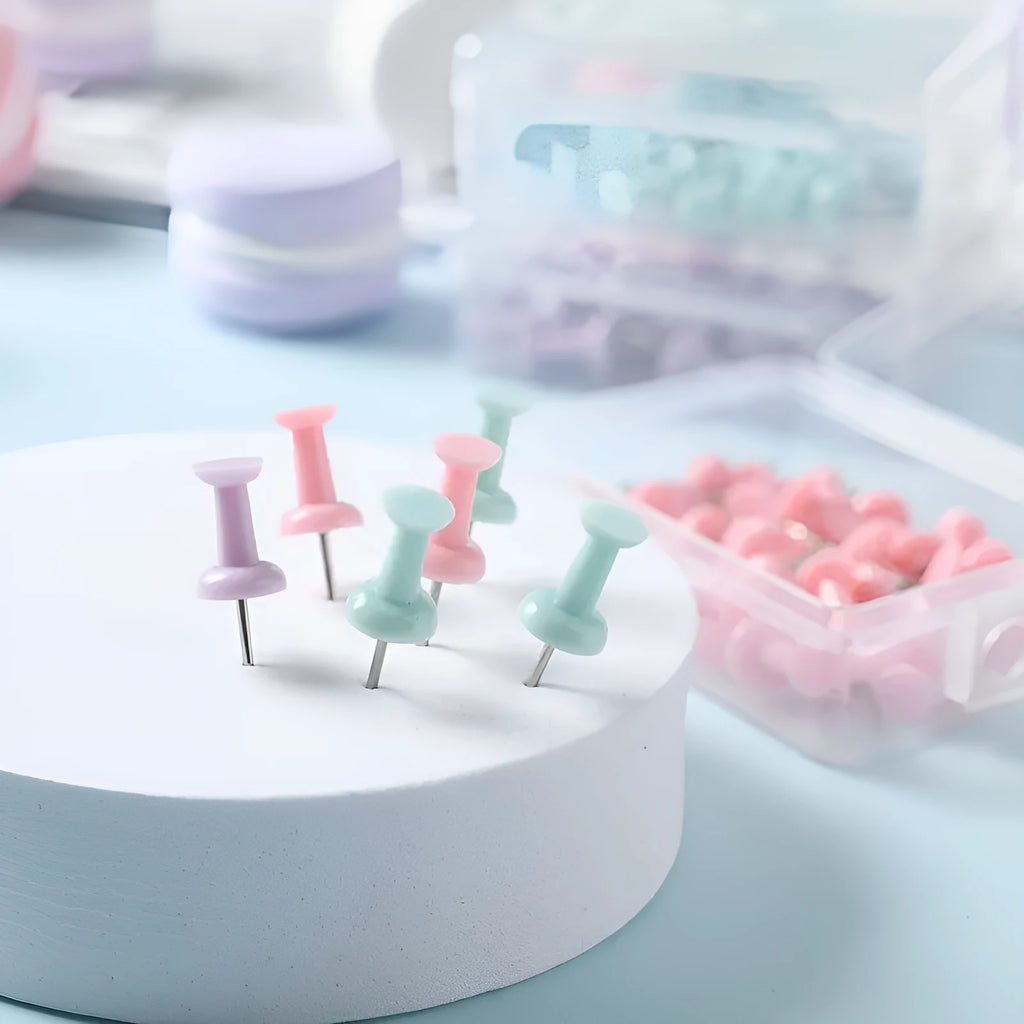 Plastic push pins in cherry blossom pink, mint green, and lavender colours, showing both large and small sizes in a box.