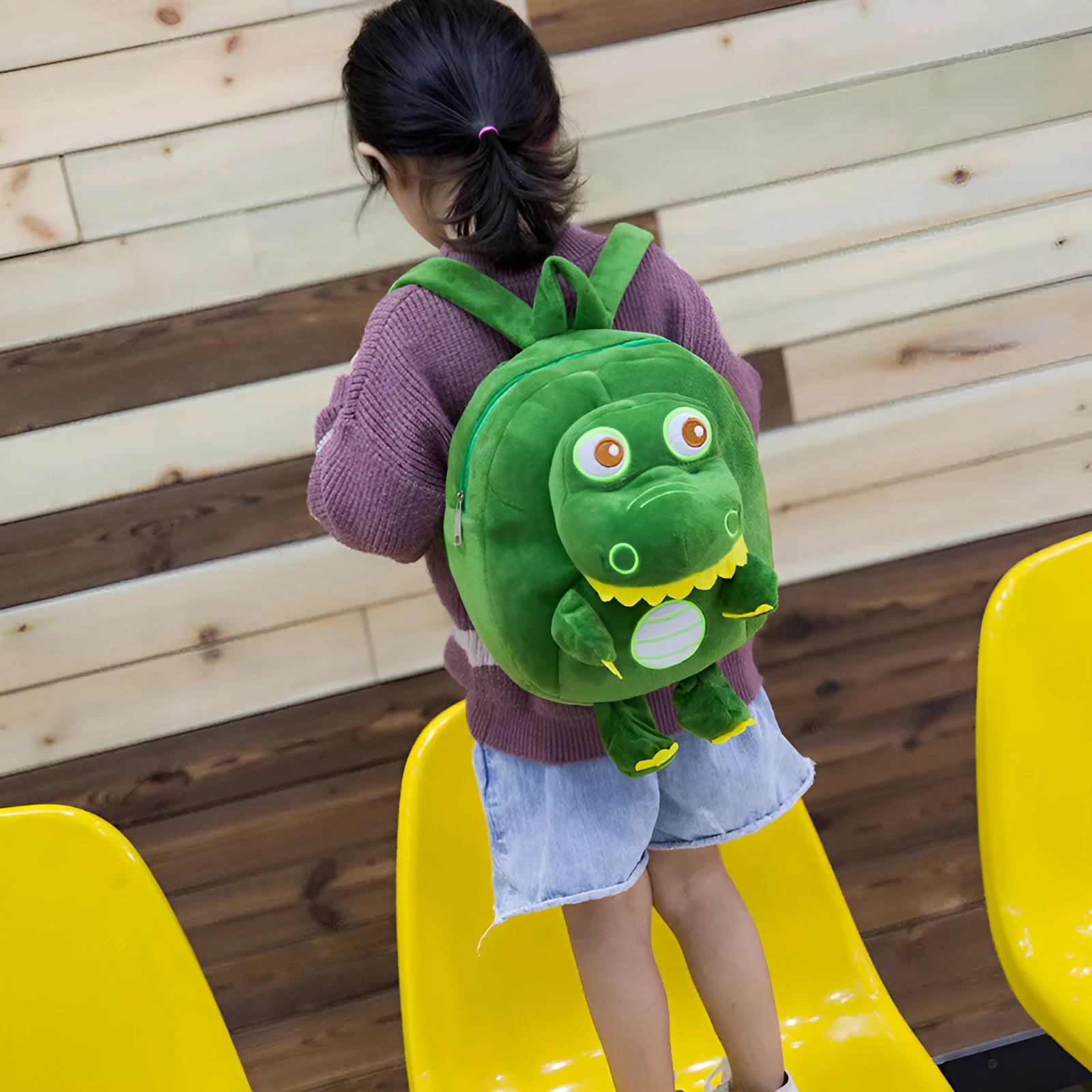Dinosaur plush backpack with soft handle and embroidery details in children's backpack style