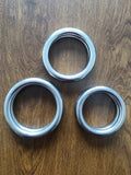 Iron Arm Skill Wing Chun carbon steel power training ring in three sizes on a plain background.