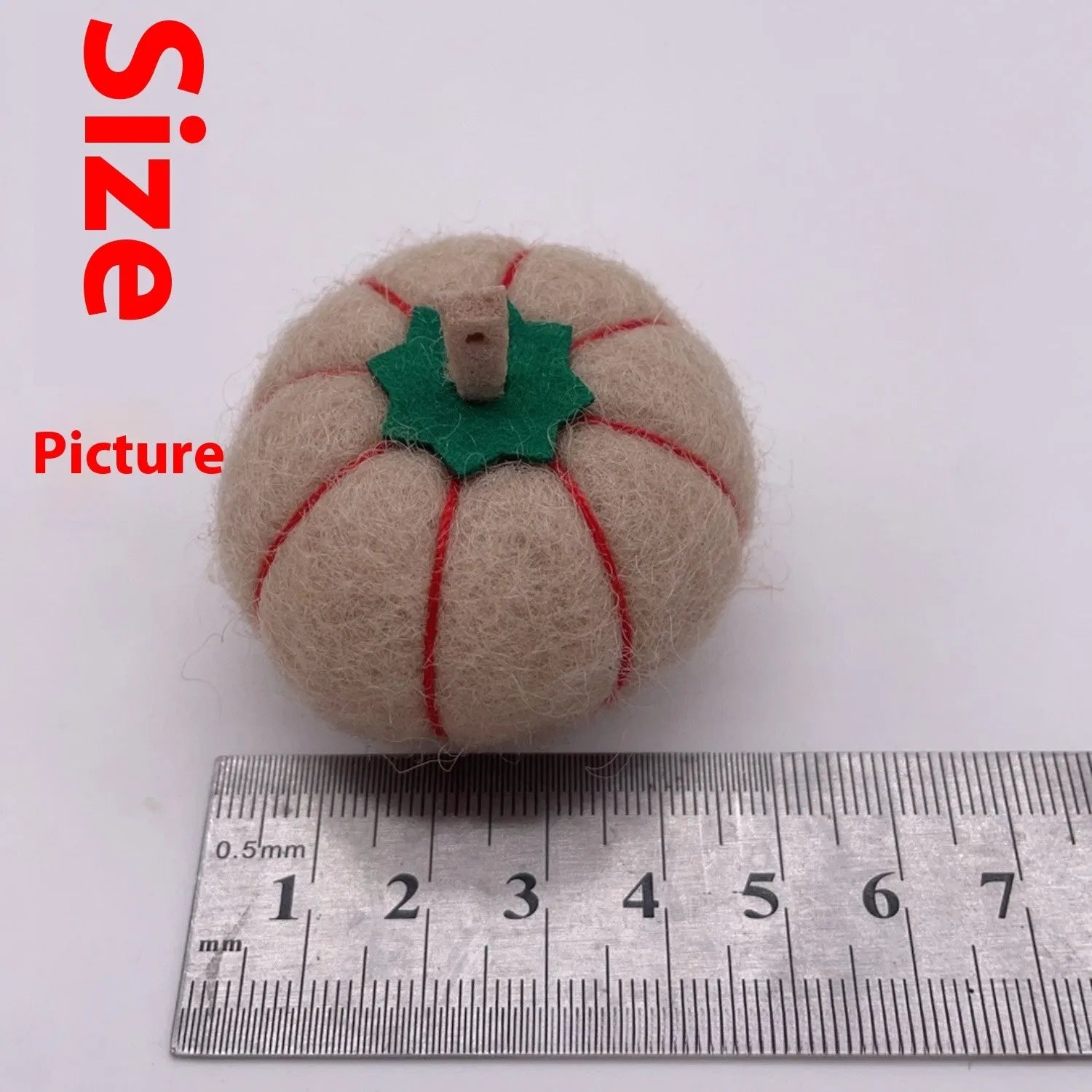 Wool felt pumpkin ornament measuring 5cm diameter in autumn colours for miniature displays