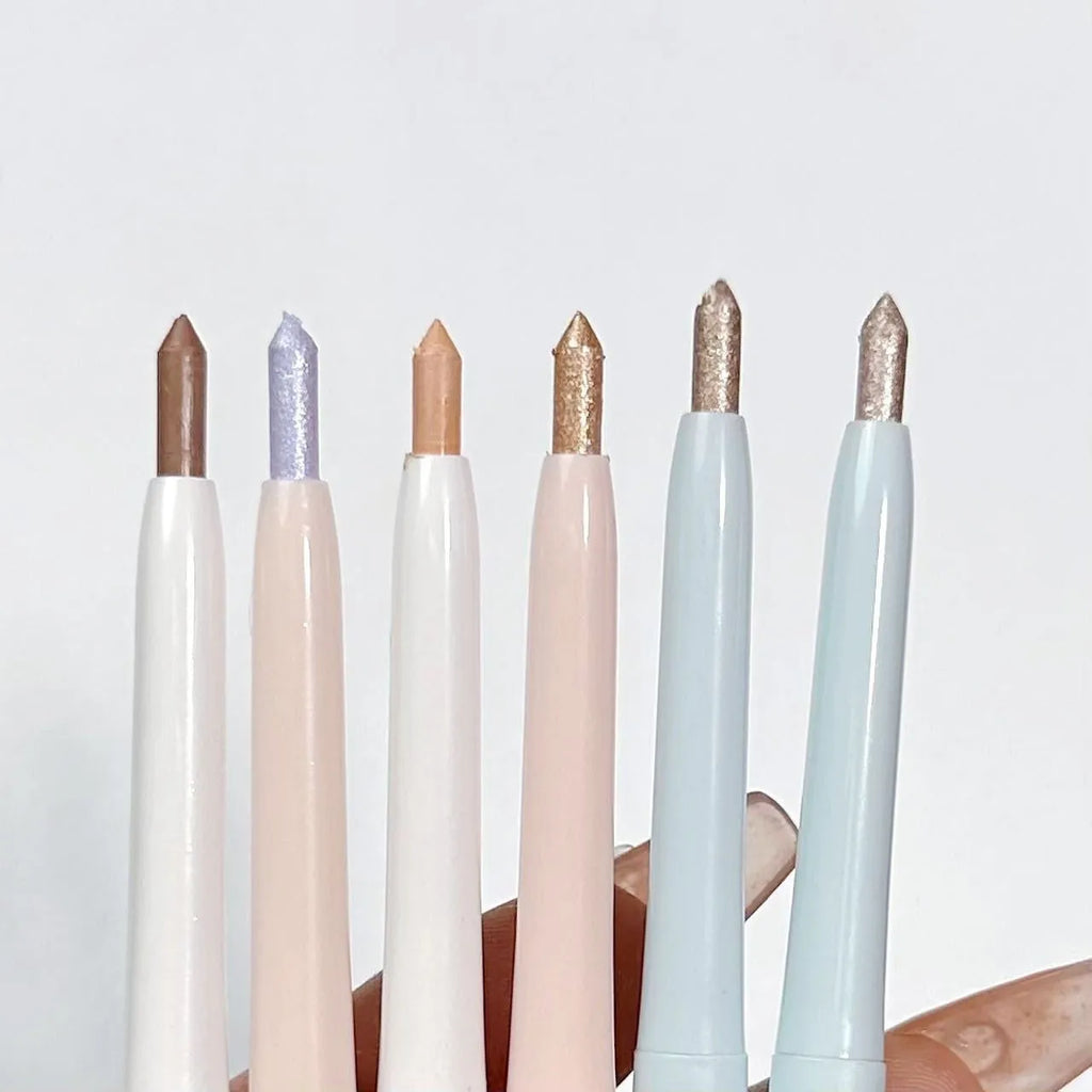 Waterproof eye shadow pen in a display showing its range of 16 colours including beige, pink, gold, and purple.