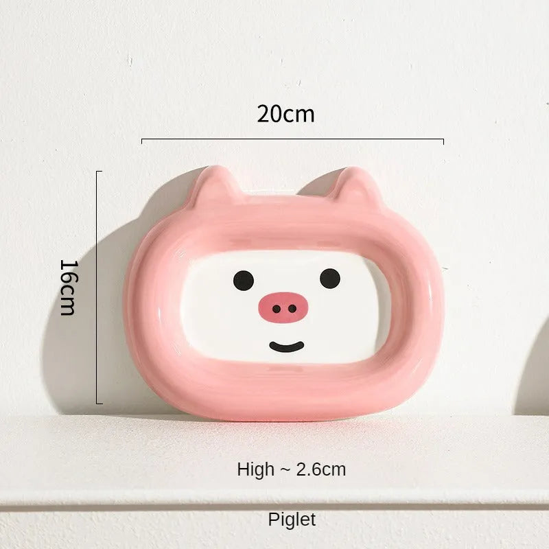 Ceramic pet bowl with animal motif design and raised base for cat or small dog feeding