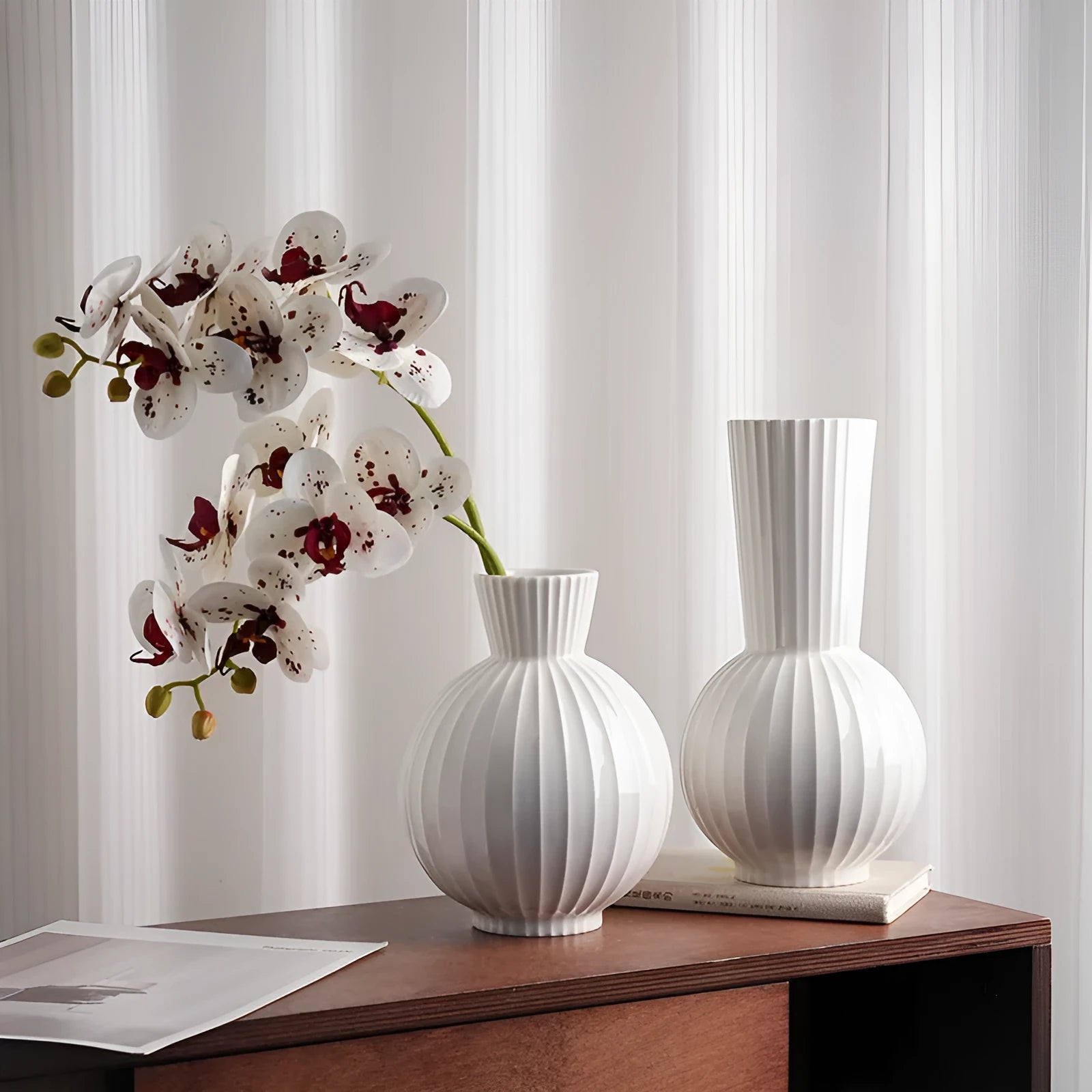 White ceramic ball-shaped vase with striped American country design on a table.