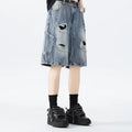 Washed black denim shorts with ripped details and a loose retro fit.
