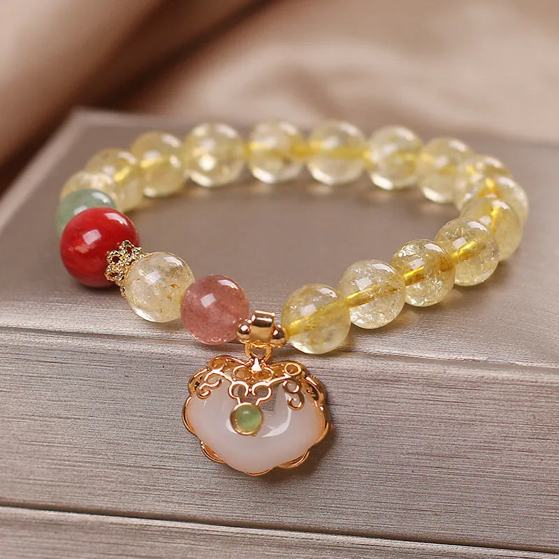 Women's alloy bracelet with a yellow citrine jade ruyi pendant on a white background.