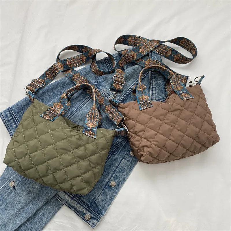 Simple shoulder messenger bag in Oxford cloth shown in multiple colours with embroidery detail and outer sandwich pocket.