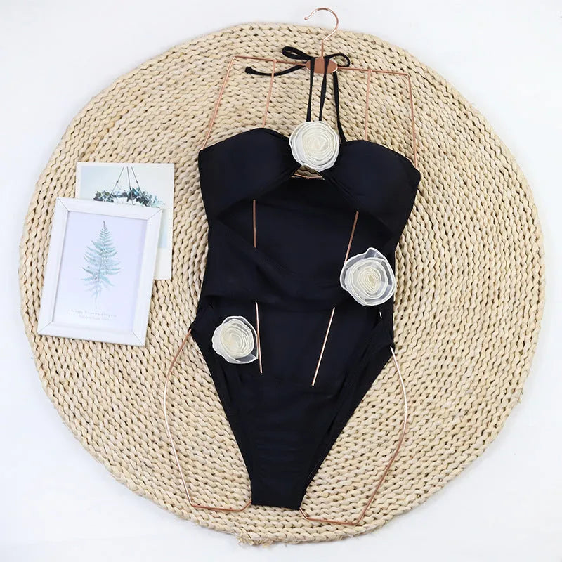 Women's black and blue stripe 3D floral print one-piece swimsuit on a hanger