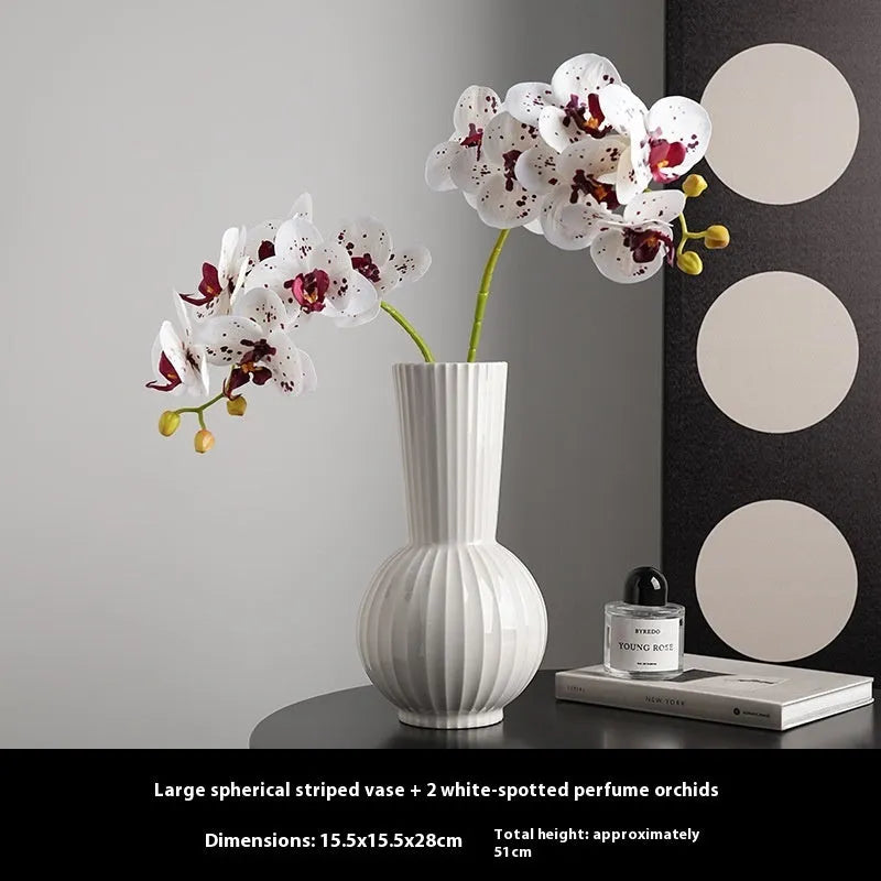 White ceramic ball-shaped vase with striped American country design on a table.