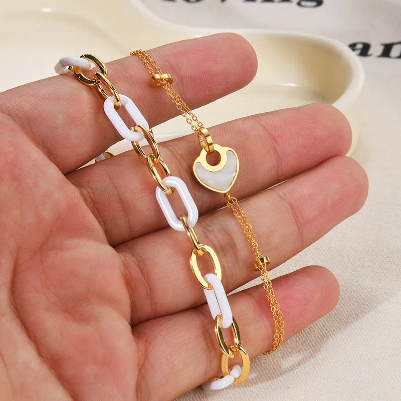 Women's stainless steel bracelet with a double-layered red heart resin charm.
