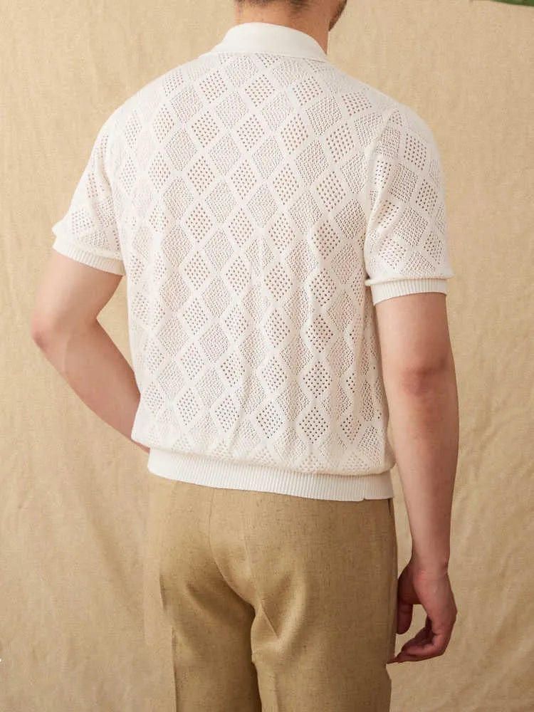 Man's light brown cotton cardigan with a front zipper, lapel collar, and short sleeves laid flat.