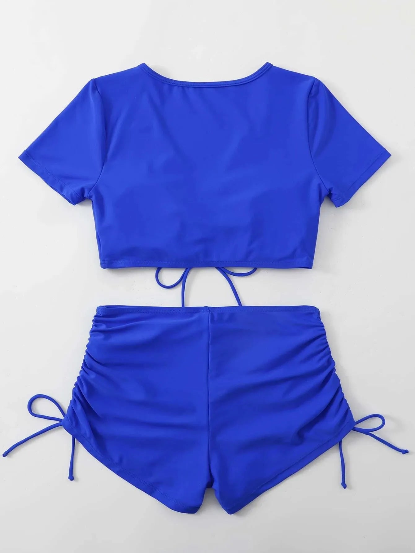Women's dark green lace-up front swimsuit top with bow and matching shorts