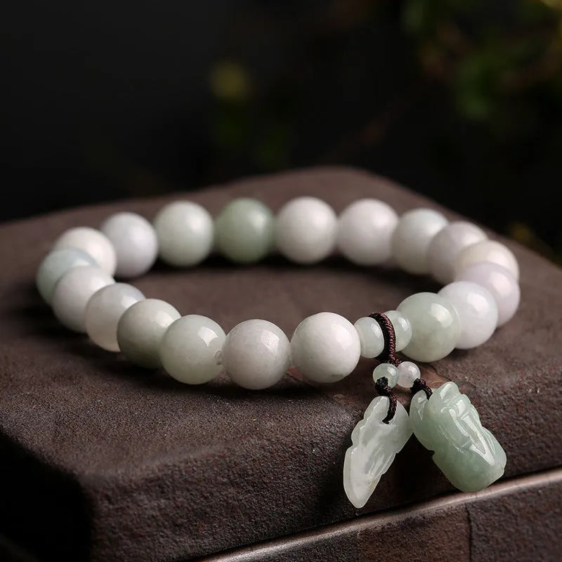 Natural green jade bracelet with a hanging Maitreya Buddha charm on a geometric band.