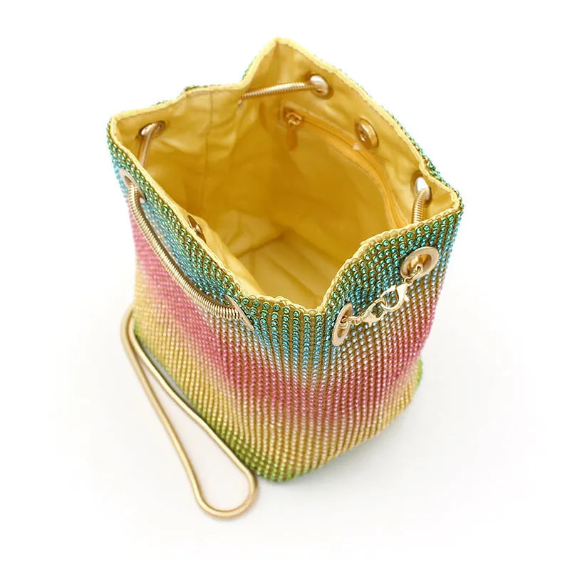 Soft multicolour rhinestone bucket bag with drawstring closure for evening wear.