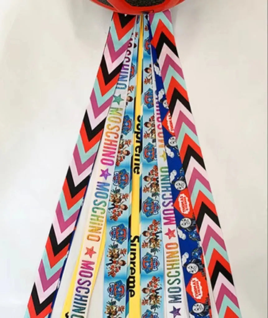 Decorative ribbon streamer for a child's ski or skating helmet in various colour options.