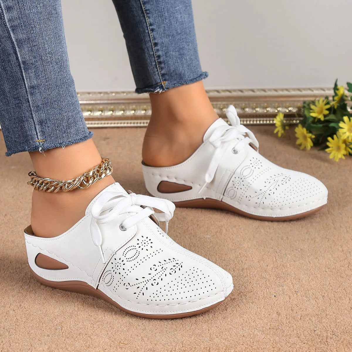 Women's black lace-up wedge slippers with a suede upper and hollow-out rubber sole on a light background.