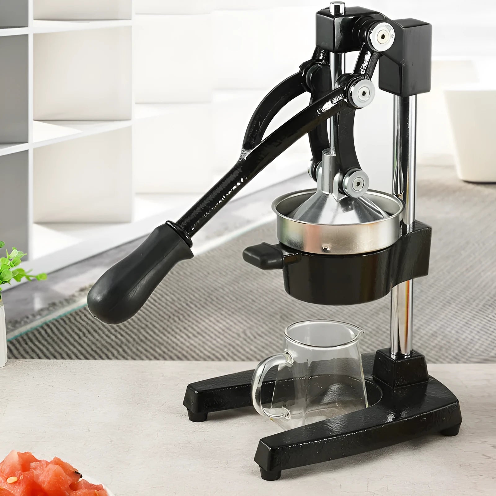 Black or white manual cast iron juicer with stainless steel funnel, 40cm tall.